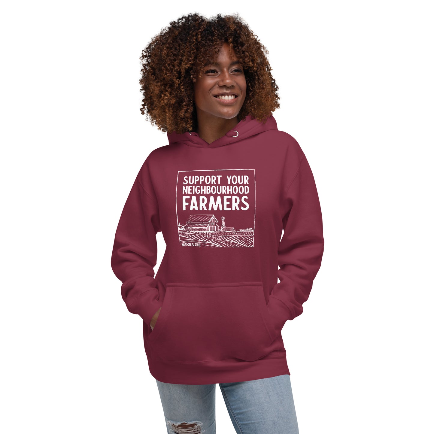 Person wearing a maroon hoodie with 'Support Your Neighbourhood Farmers' text on a white background