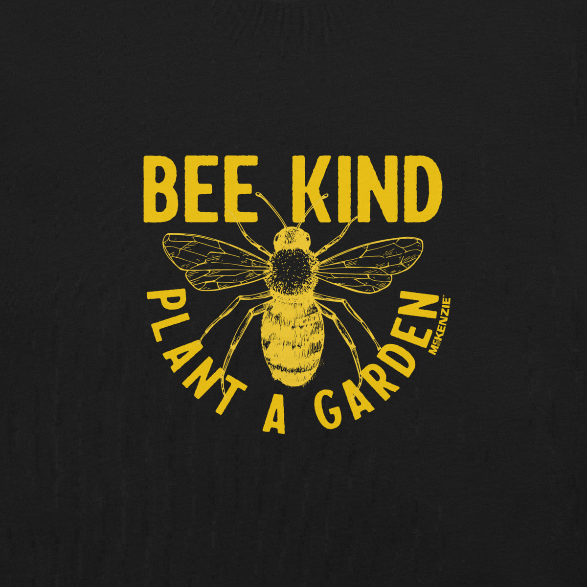 A black graphic print featuring a yellow distressed bee in the center, with the words 'BEE KIND' above and 'PLANT A GARDEN' below, plus a small vertical brand mark reading 'MCKENZIE' on the right side of the bee.