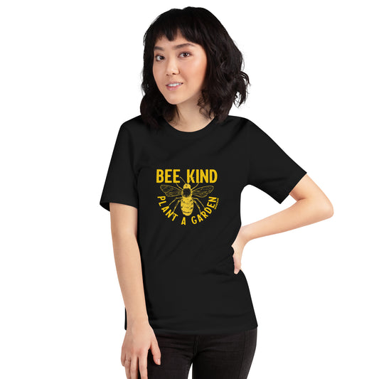 A black unisex shirt with a graphic print of a bee, with the text 'BEE KIND' and 'PLANT A GARDEN' on female model
