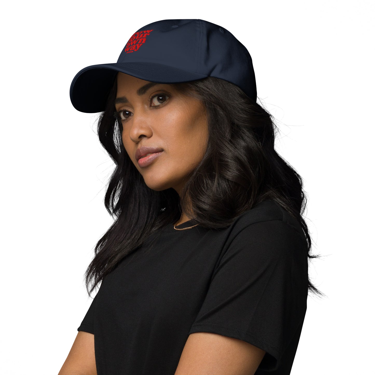 Woman wearing a black cap with a red logo on a white background