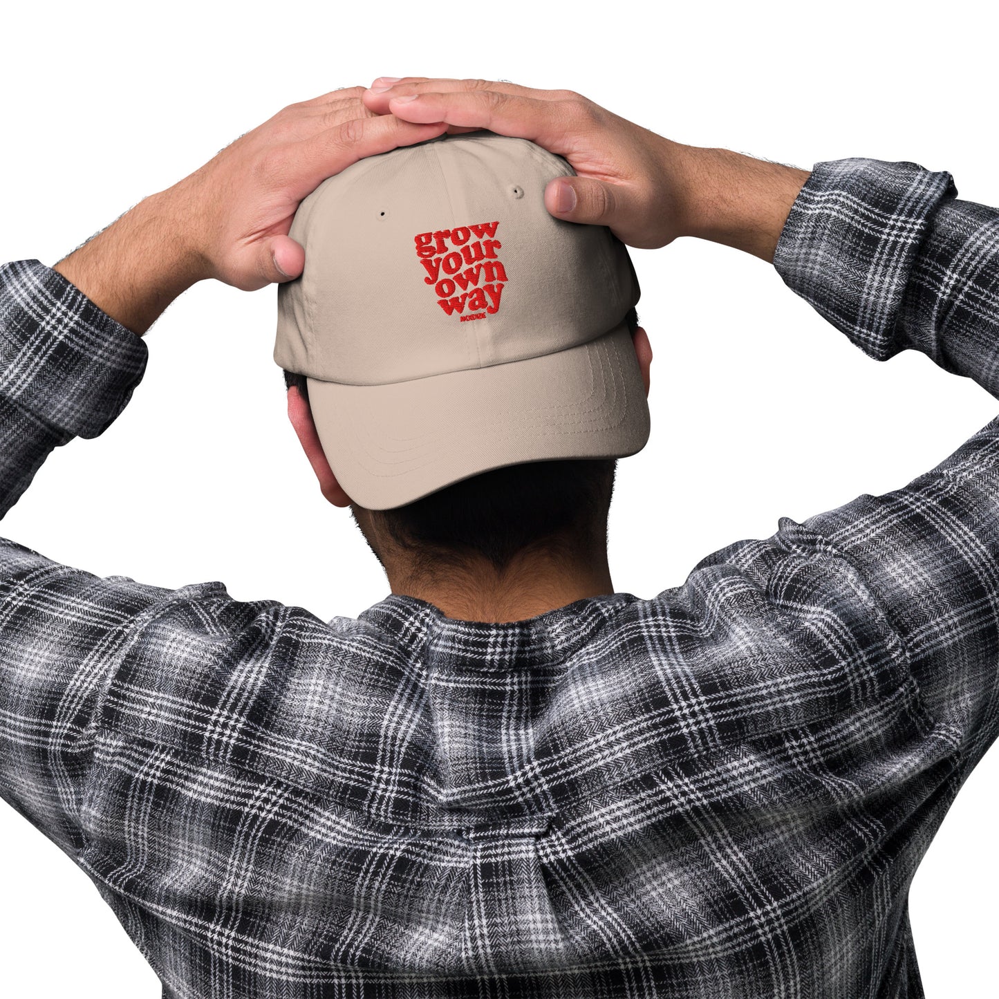 Person wearing a beige cap with 'i will be light' text on a white background