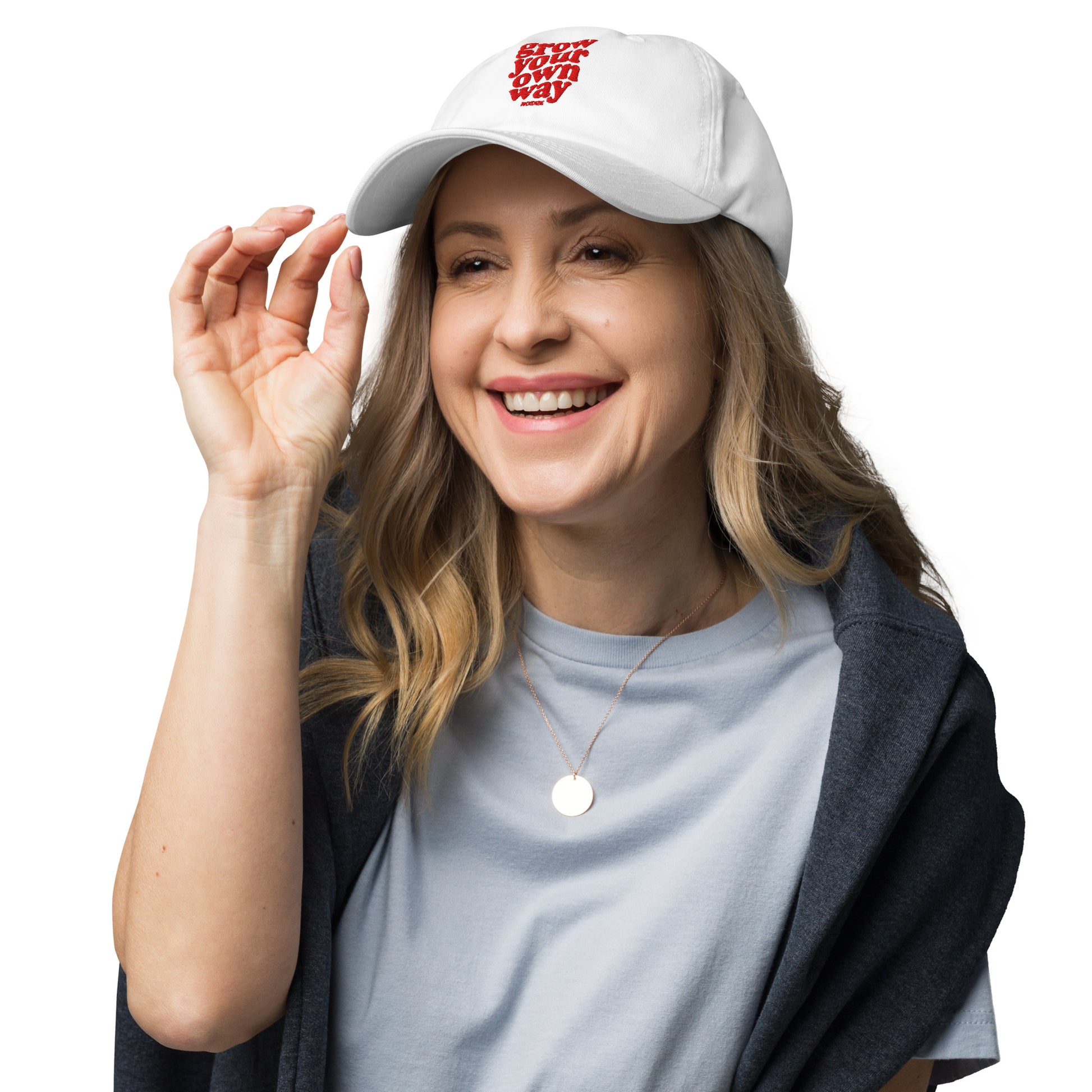 Woman wearing a white cap and smiling on a white background