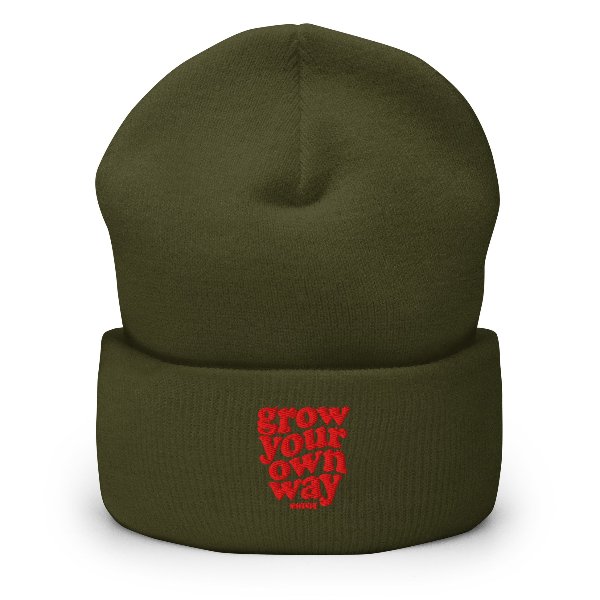 An olive green knit beanie hat with a folded cuff, featuring red embroidered text that reads 'grow your own way', shown on a plain white background.