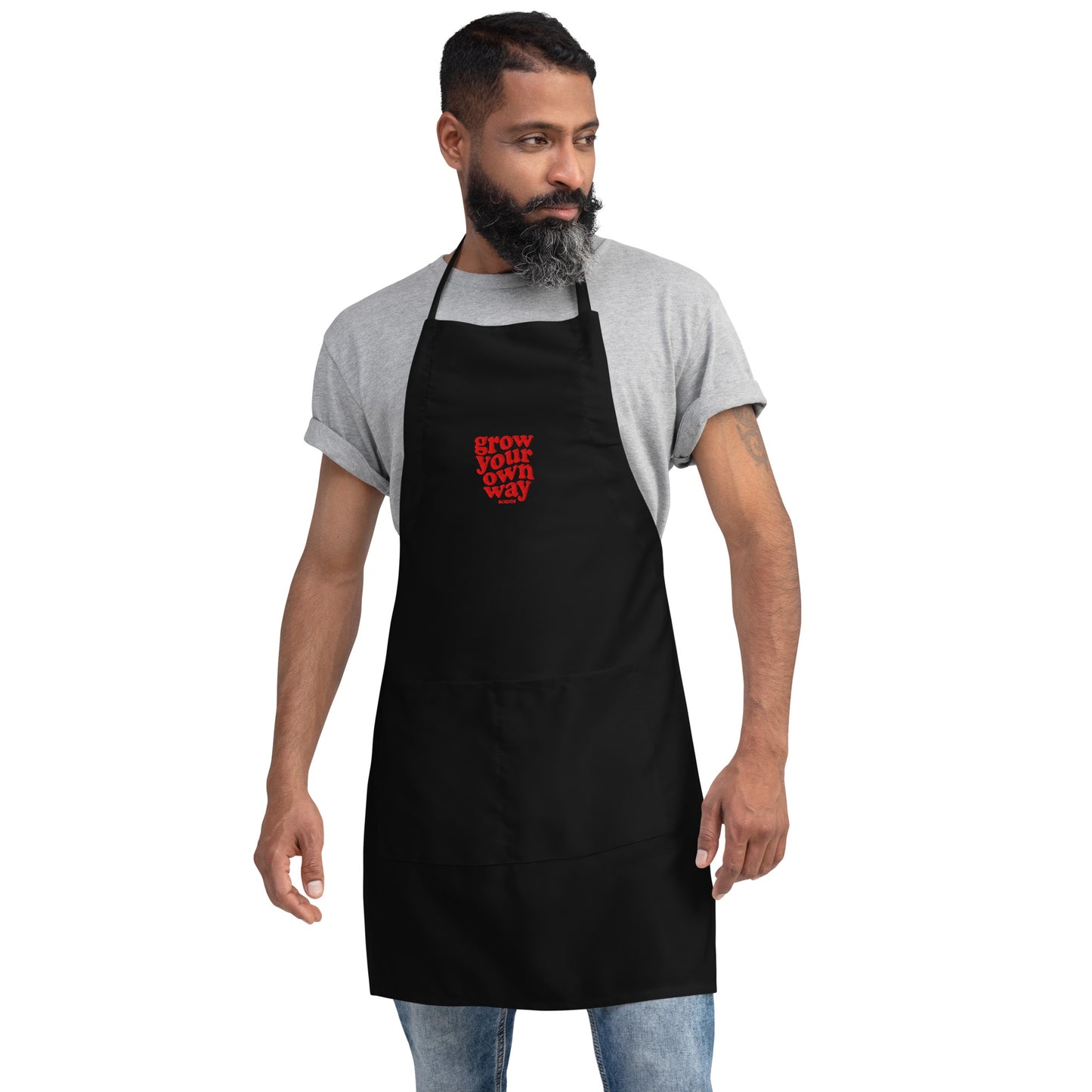 Man wearing a black apron with red text on a white background