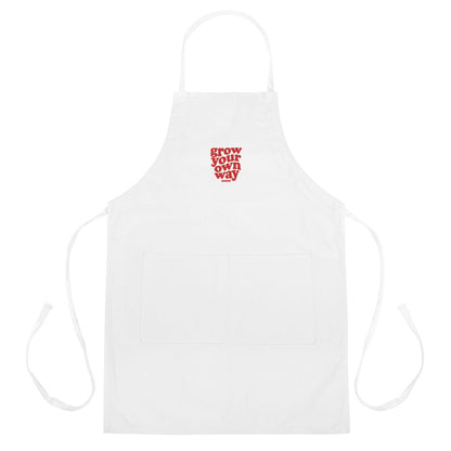 White apron with red text 'Grow Your Own Way' on a white background
