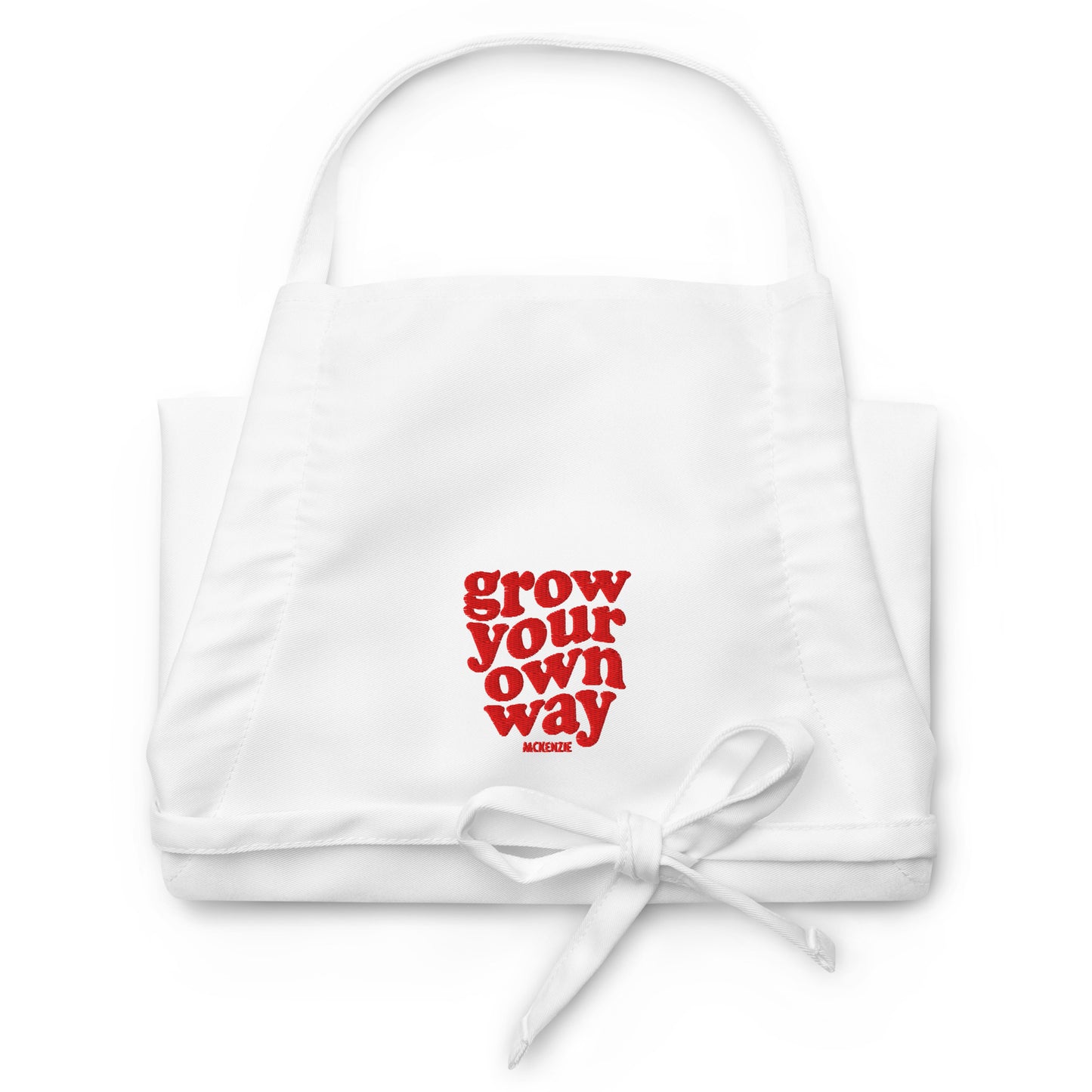 White apron with red text 'grow your own way' on a white background