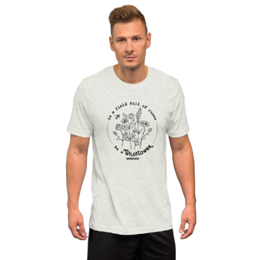 A man wearing a light heather gray t-shirt with a black circular graphic on the chest 