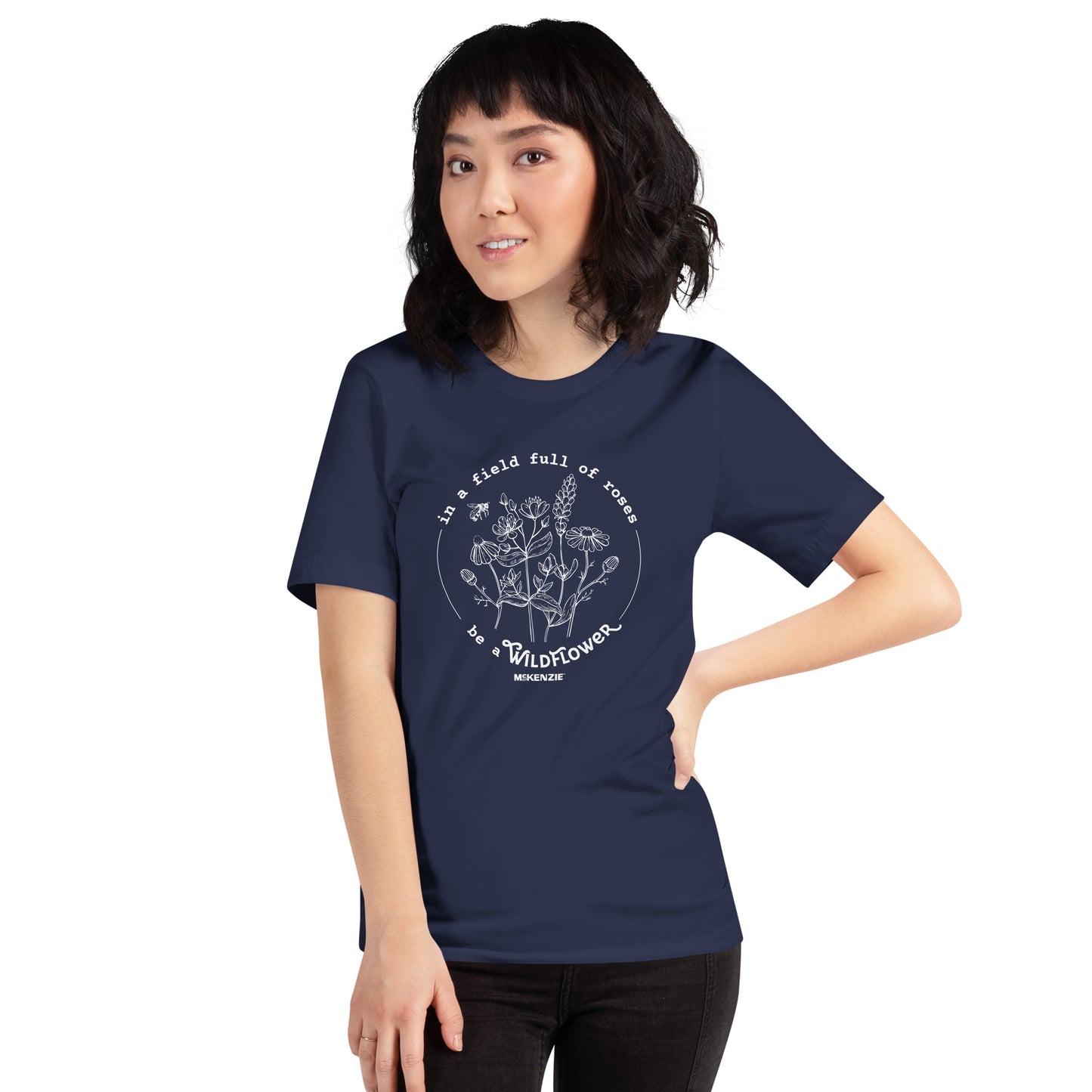 Person wearing a navy blue t-shirt with a white floral design and text on a white background