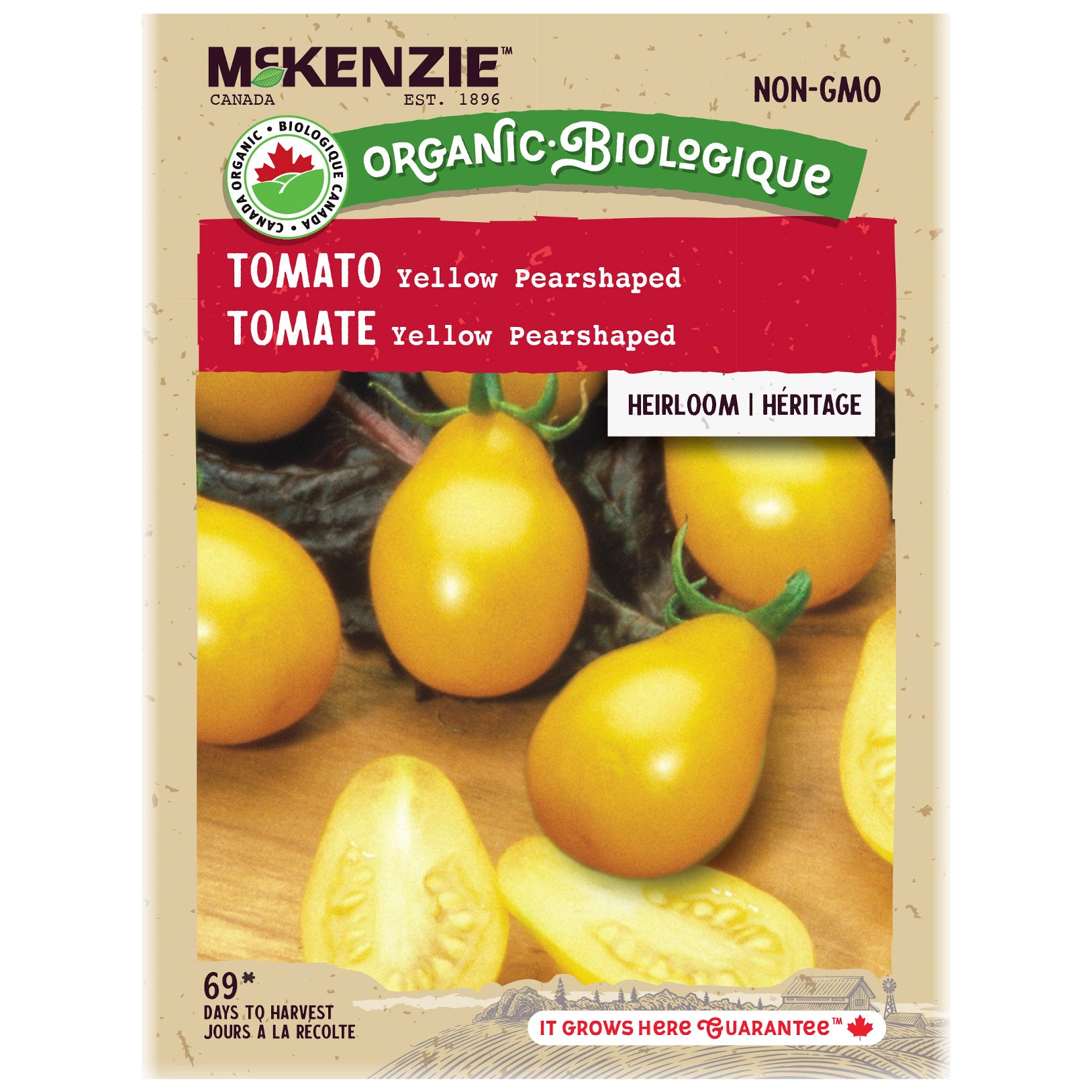 Mckenzie Organic tomato seed packet with yellow pear-shaped tomatoes on a wooden surface.