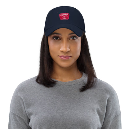 Woman wearing a navy blue cap with a logo on a white background