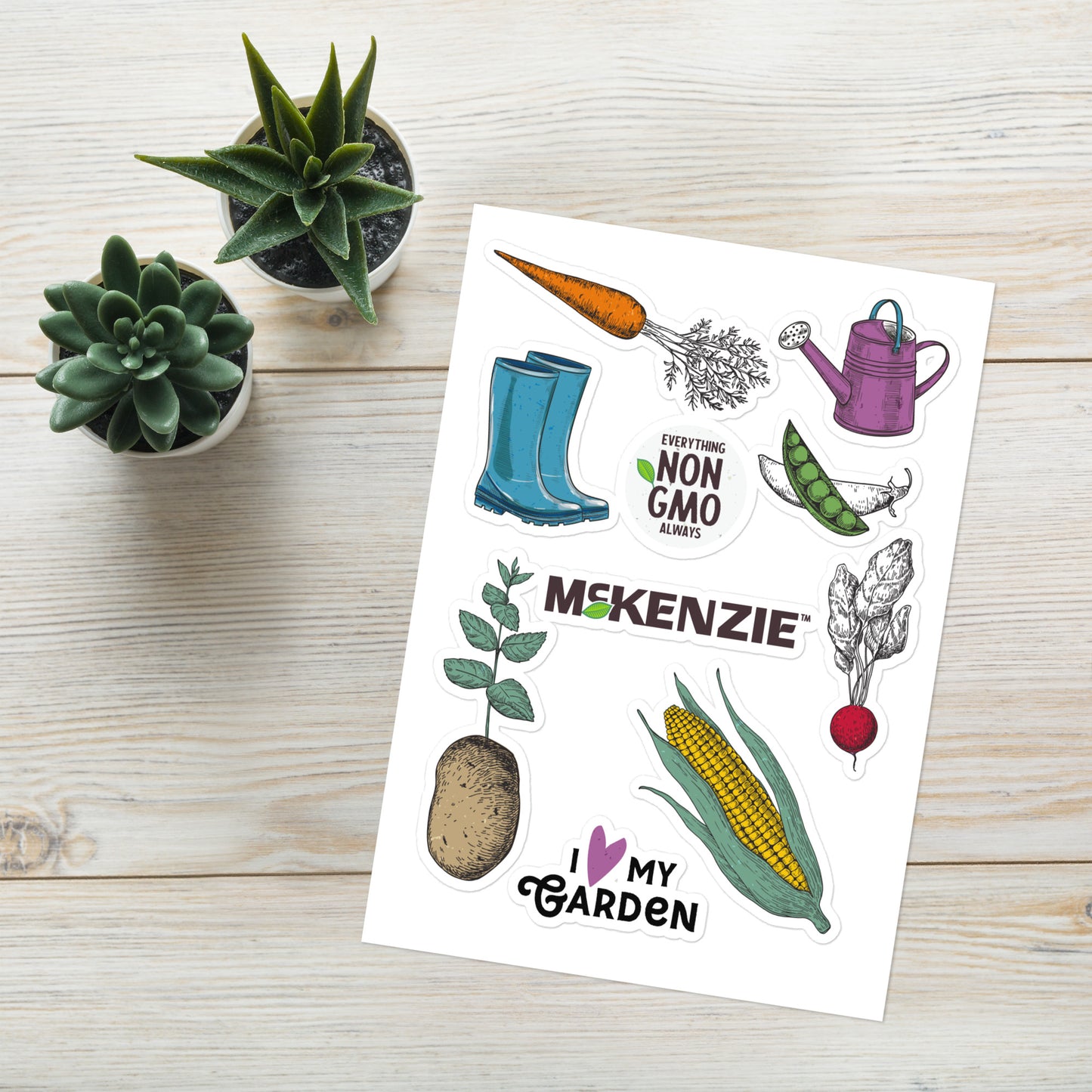 Sheet of gardening-themed stickers with plants and tools on a wooden surface.