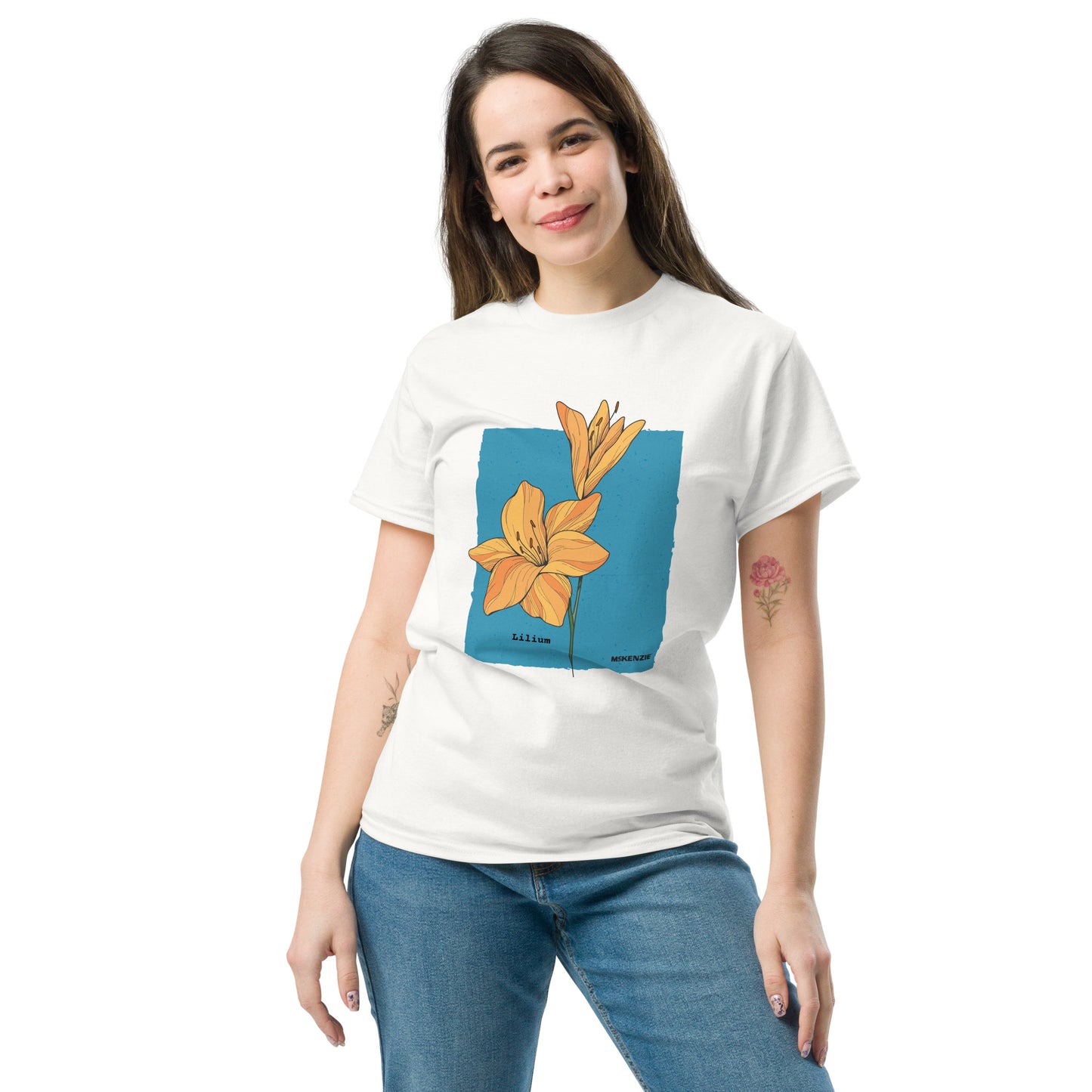 Woman wearing a white t-shirt with a graphic design of a flower on a blue background