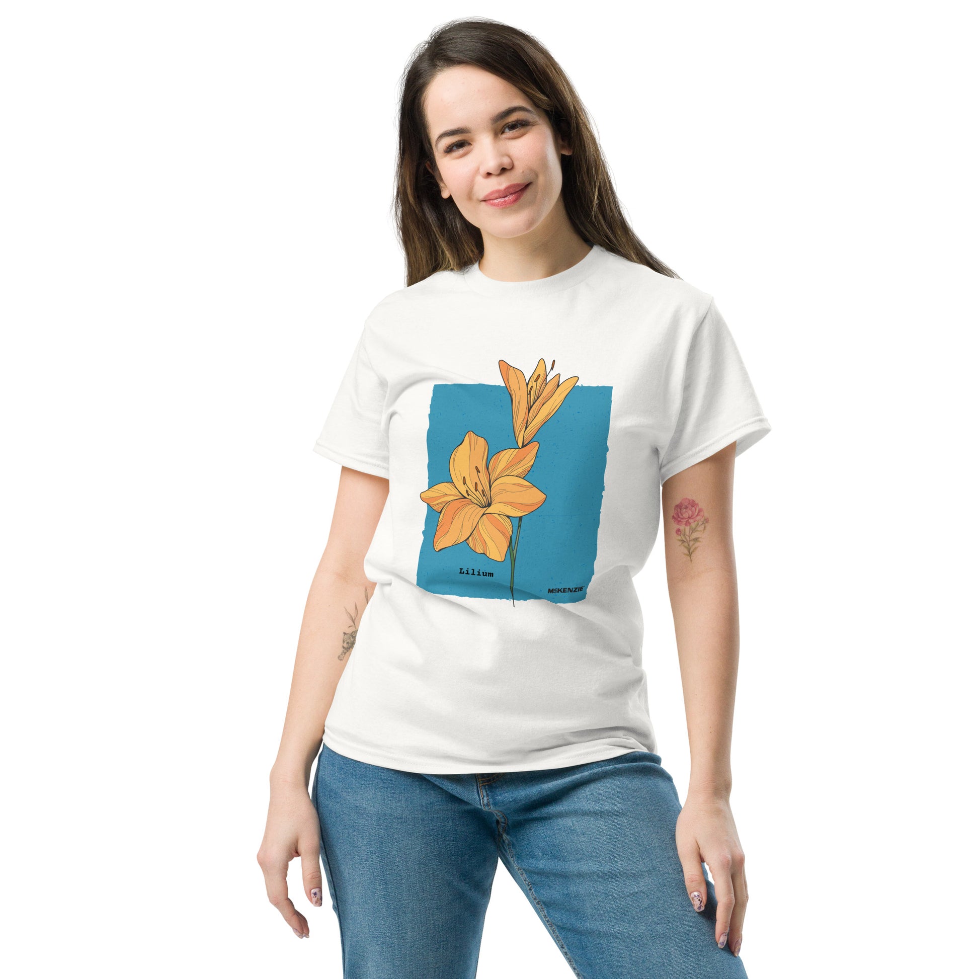 Woman wearing a white t-shirt with a graphic design of a flower on a blue background