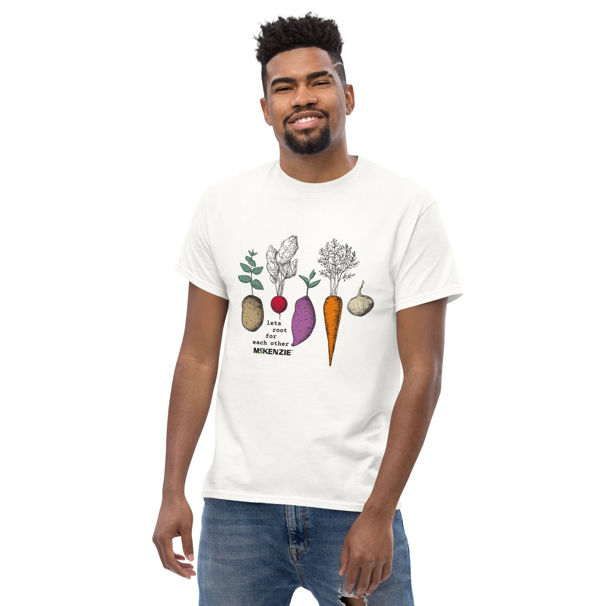 Man wearing a white t-shirt with vegetable graphics on a white background